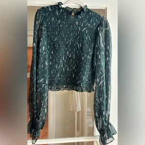 Do & Be green long sleeve turtle neck top with see through sleeves. Size M.